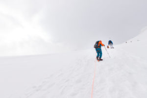 Climber on the way to the Bishorn summit, roped on during a blizzard and heavy fog over the glacier Climber on the way to the Bishorn summit, roped on during a blizzard and heavy fog over the glacier